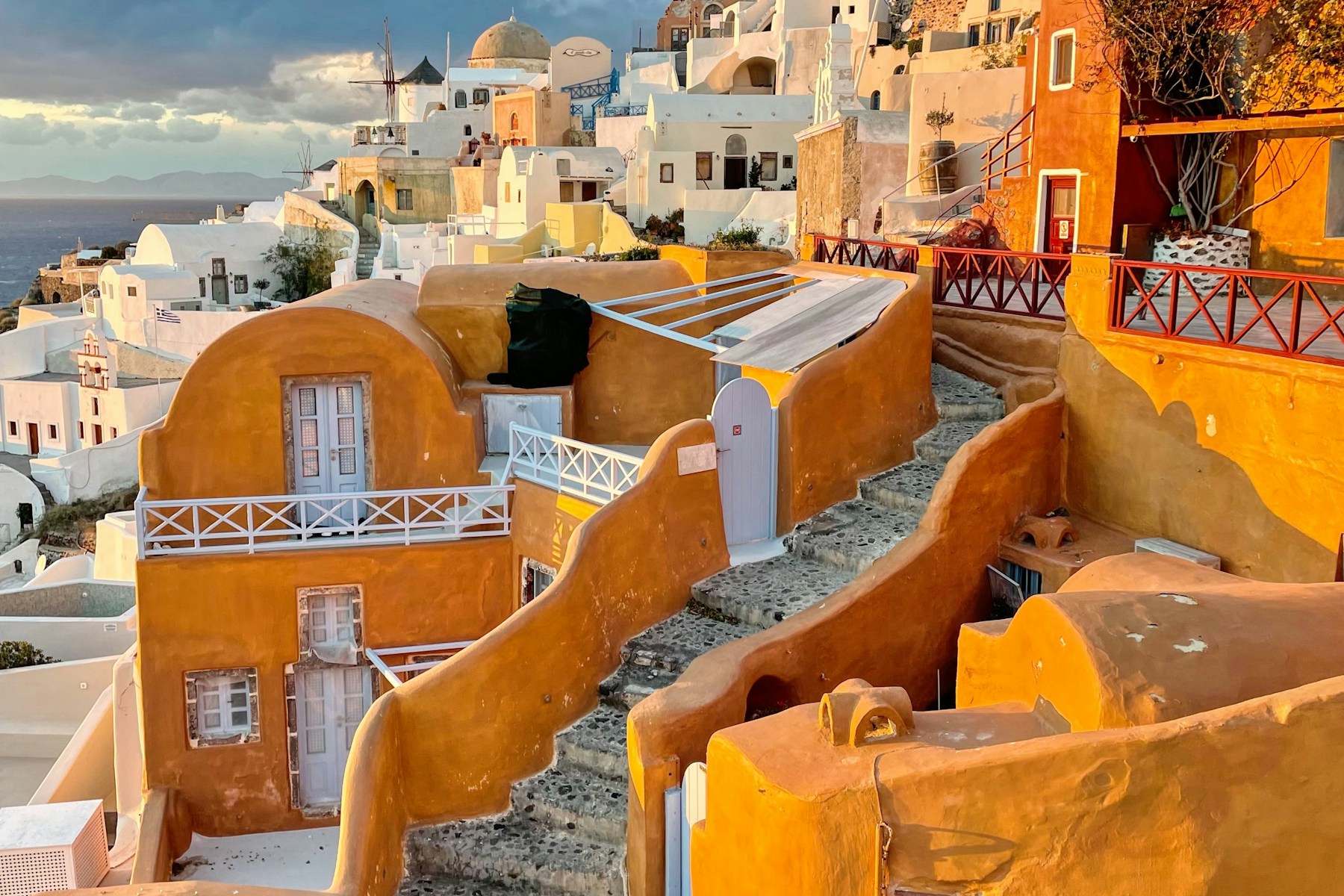 Sun-washed buildings stepping down the Santorini caldera